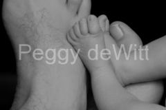 Baby-Feet-With-Dads-BW-v-2604